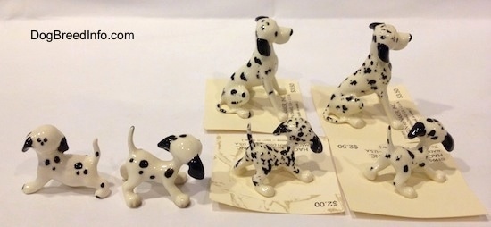 The side of six Dalmatian figurines that all have black ears.